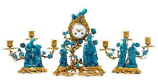 A French Gilt Bronze and Chinese Porcelain Clock Garniture Height of clock 15 inches.