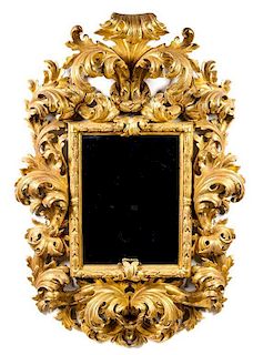 An Italian Baroque Style Giltwood Mirror Height 73 x width 45 inches.