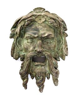 * A Neoclassical Patinated Cast Stone Mask Height 16 inches.