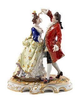 A German Porcelain Figural Group Height 12 inches.