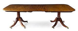 * A George III Style Mahogany Double Pedestal Dining Table Height 28 x depth 55 inches.