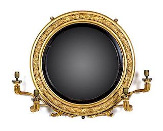 * A Regency Giltwood and Ebonized Convex Girandole Mirror Height 25 x diameter 30 inches.