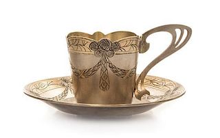 * A Russian Art Nouveau Silver Cup and Saucer, Mark of Fifth Artel, Moscow, early 20th century, the cup having an undulating rim