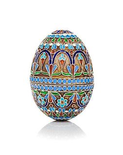 A Russian Enameled Silver-Gilt Egg, 19th Century, in two parts with allover floral decoration.
