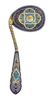 * A Russian Silver-Gilt and Enamel Caddy Spoon, Mark of Antip Kuzmichev, Moscow, late 19th century, the handle having polychrome