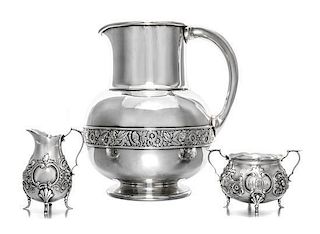 * An American Silver Pitcher, Gorham Mfg. Co., Providence, RI, 1883, having a flattened spherical body with a cylindrical neck,