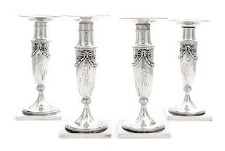 * A Set of Four American Silver Candlesticks, Whiting Mfg. Co., New York, NY, each baluster stem with applied bellflower garland