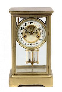 A Brass and Glass Regulator Clock Height 10 3/4 inches.