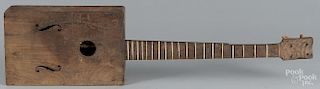 Primitive walnut stringed instrument, 19th c., with traces of paint decoration, 35'' l.