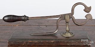 Wrought iron sugar nippers, 19th c., mounted to a molded walnut base, 11 3/4'' w.