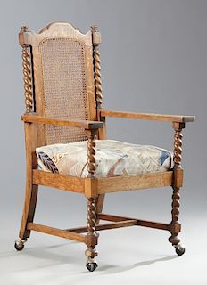 Arts and Crafts Carved Oak Cane Back Armchair, c.
