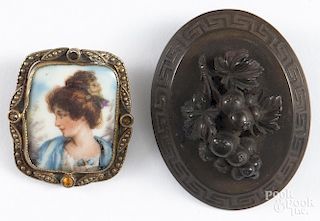 Czechoslovakian hand painted porcelain brooch, featuring the portrait of a woman, with a brass frame