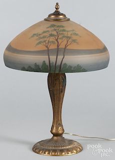 Reverse painted table lamp, early 20th c., with a gilt cast iron base, 22 1/2'' h., 16'' dia.