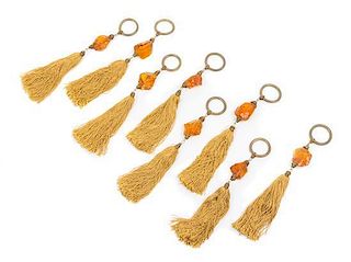 * A Set of Sixteen Amber Drapery Ornaments Length 12 1/4 inches.