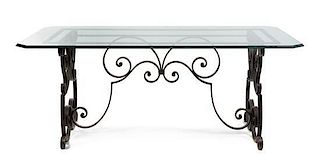 * A European Wrought Iron and Glass Breakfast Table Height 29 1/2 x width 63 1/2 x depth 31 inches.