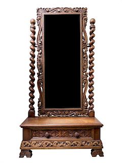A Jacobean Style Walnut Cheval Mirror Height 68 x width 33 x depth 12 1/2 inches.