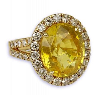 GIA Certified 12.65 Carat Oval Cut Yellow Sapphire and 18 Karat Yellow Gold Ring accented throughout with Round Brilliant Cut Diamonds