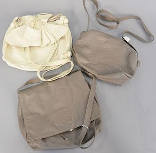 Three Carlos Falchi leather handbags including two cream, white, and tan bag and a...