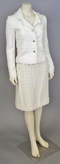 Chanel two piece suit including white jacket with novelty yarns and fringe trim with matching skirt.
