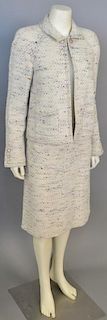 Chanel two piece suit having off-white wool jacket with speckled color throughout and matching skirt.