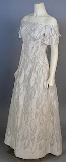 Arnold Scaasi, c. 1985, Evening dress of cream silk damask, with cut-outs in leaf shapes; laid over net ...