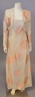 Mary McFadden, c. 2000, Evening dress and jacket of gold/white silk, woven with large design of peach chrysanthemums. The gown is strapless; the jacke