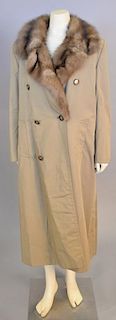 Maximilian New York trench coat lined with fur and having fur collar.