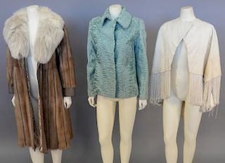 Three womens fur pieces including fur and leather coat, fur shawl, and light blue fur jacket.