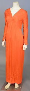 Christian Dior, Autumn/Winter 1988-1989, Evening dress of orange silk satin. Long, straight sleeves that fasten with self-covered buttons at the wrist