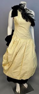Christian Dior, Autumn/Winter 1982, Evening dress of yellow silk moire, one-shoulder, with dropped waist and bubble skirt. Trimmed around neckline and