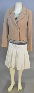 Chanel three piece suit with brown tweed zip-up jacket, cotton pleated cream colored skirt and a long sleeve striped suit shirt with knit flower accen