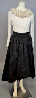 Mary McFadden, c. 1990s, Evening ensemble consisting of a black silk skirt with a dipped hemline, and a white crinkle-pleated silk bodice. The necklin
