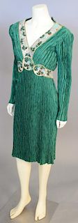 Mary McFadden, c. 1990s, Christmas dress, knee-length, of green crinkle-pleated silk, embellished with bands of holly designs worked with sequins and 
