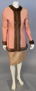 Mary McFadden, c. 1990s, Jacket and skirt set. The boxy-cut jacket is made of iridescent red/yellow silk, creating a pale copper color, quilted in set