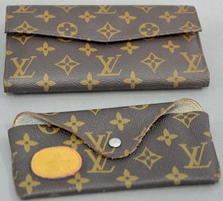 Louis Vuitton wallet and a small case.
