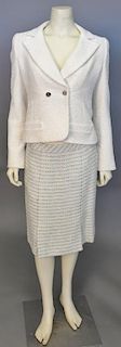 Chanel two piece suit with ivory colored jacket and tweed green and black skirt.