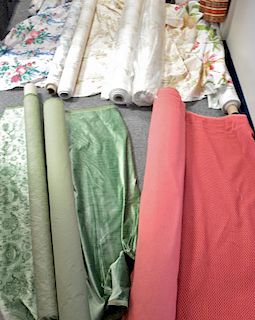 Ten rolls of fabric including satin, velvet, floral print, etc.