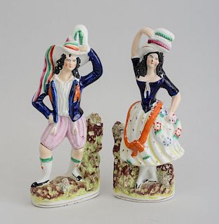 PAIR OF STAFFORDSHIRE POTTERY FIGURES OF A YOUTH AND A GIRL