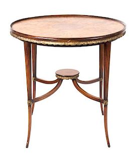 A Continental Walnut and Parcel Gilt Occasional Table Height 27 x diameter 27 inches.
