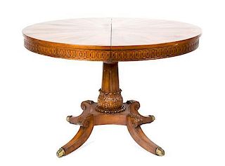 A Continental Inlaid Walnut Table Diameter 44 inches (closed); width of each leaf 23 7/8 inches.