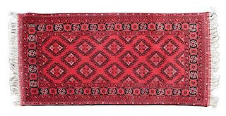 A Turkoman Wool Rug 6 feet 8 inches x 3 feet 3 1/2 inches.