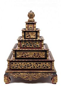 An Indonesian Parcel Gilt Red Lacquer Five-Tiered Bride's Box Height 20 x width 15 x depth 15 inches.