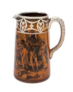 * A Silver Overlay Transfer Decorated Ceramic Pitcher Height 6 1/4 inches.