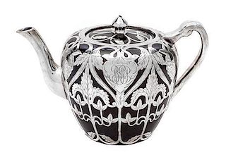* A Porcelain Silver Overlay Teapot Height 5 1/4 inches.