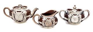 * A Ceramic Silver Overlay Dimunitive Tea Service Width of teapot 6 1/2 inches.