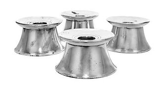 * A Set of Four French Silver Candlesticks, Cartier, having a circular rim over a flared base, weighted.