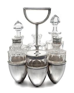 An English Silver-Plate Cruet Set, Dr. Christopher Dresser for Hukin & Heath, Birmingham, the caddy having six egg-form cups and