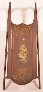 Childs sled having floral and stencil motif over brown paint, wooden and metal runners.