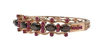 Bangle Bracelet in 14 Karat Yellow Gold with Black Star Sapphire and Rubies 