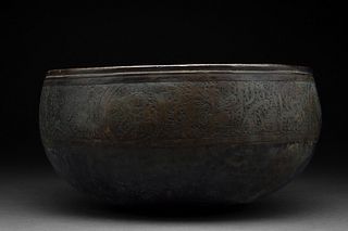 AYYUBID COPPER BOWL WITH A HUNTER ON HORSEBACK AND INTERWOVEN CALLIGRAPHY